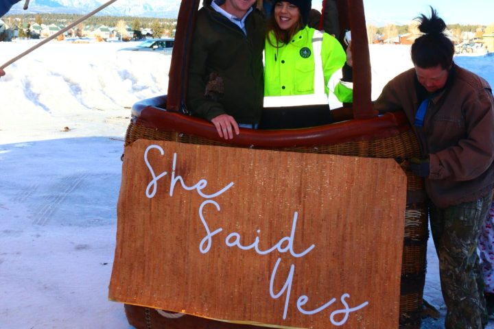 a couple smiling for the camera with a 