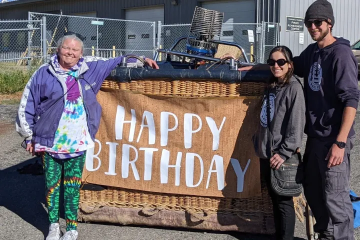 a group of people smiling for the camera with a 