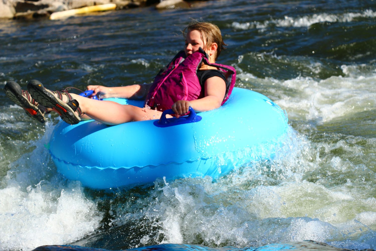 a woman tubing on a body of water with pagosa adventure in pagosa springs, colorado