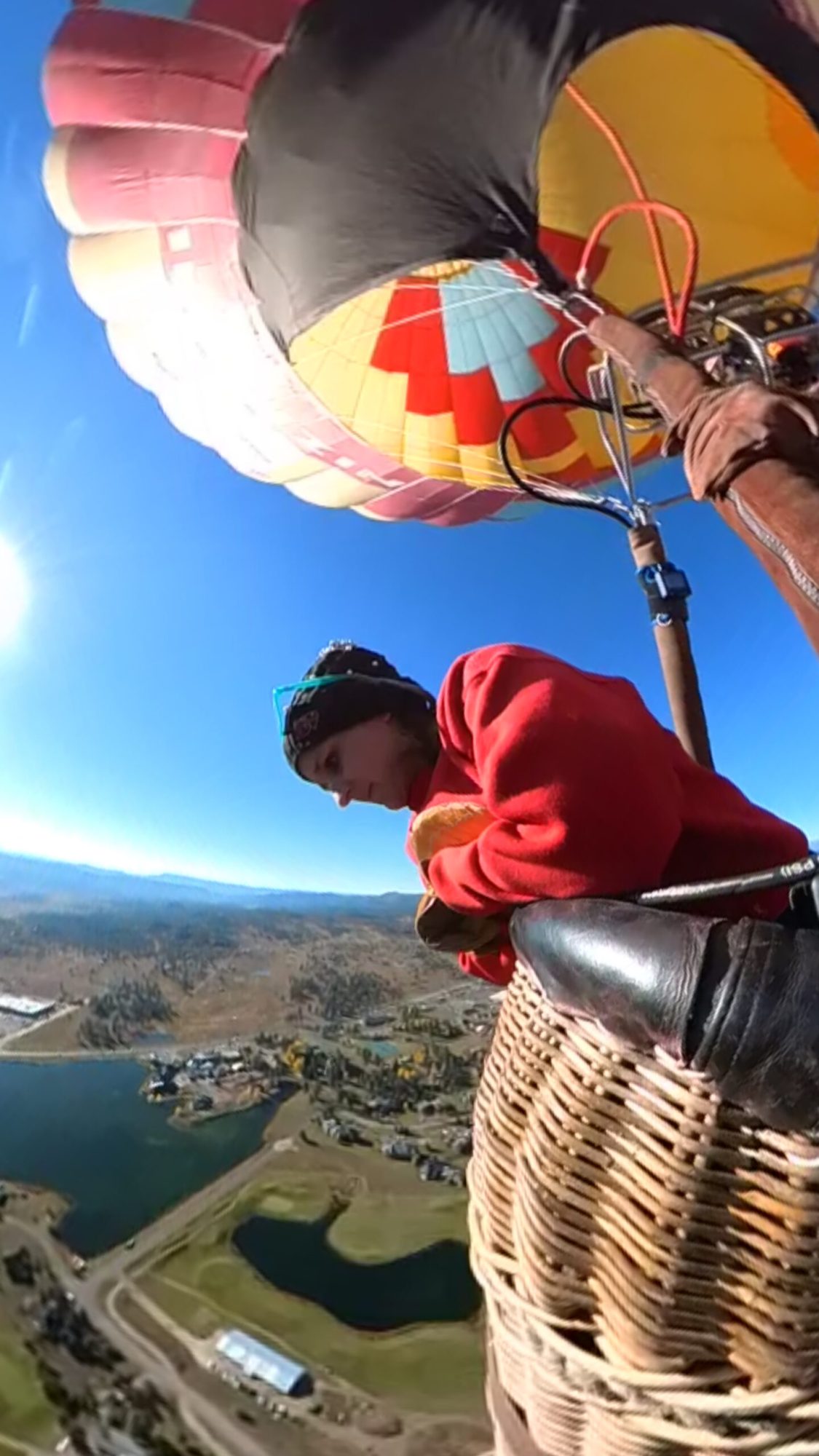 Pagosa Adventure a woman looking down at the scenery on board pagosa adventure's hot air balloon in pagosa springs, colorado