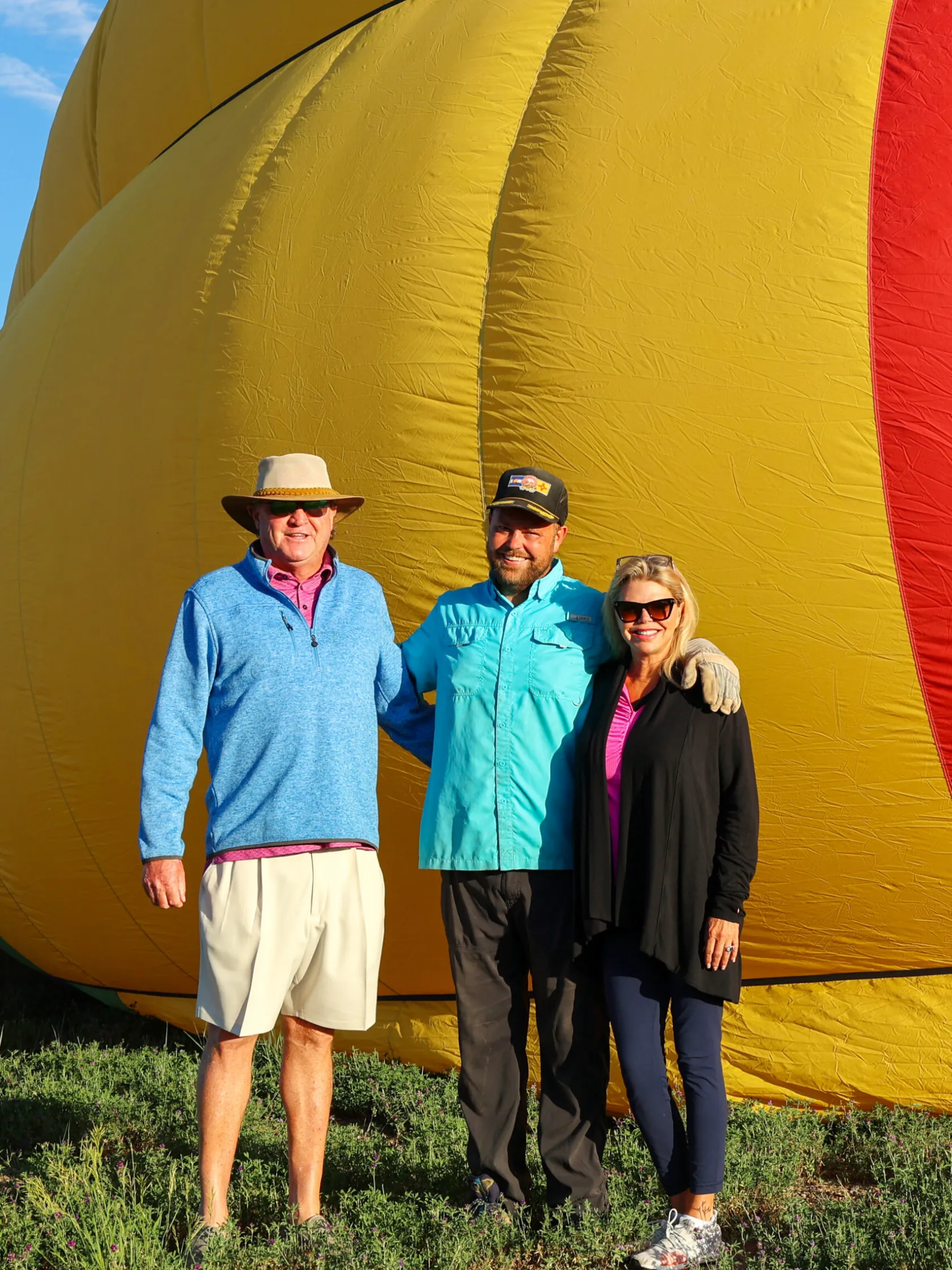 a group of people posing for the camera in front of pagosa adventure's hot air balloon in pagosa springs, colorado