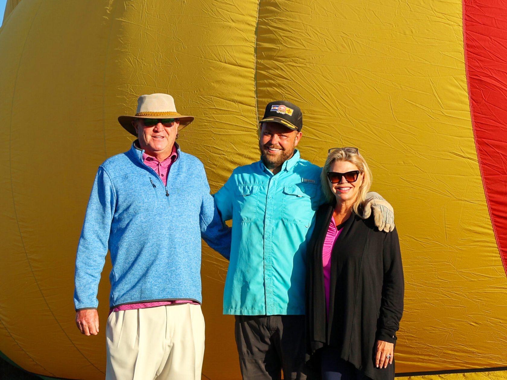 a group of people posing for the camera in front of pagosa adventure's hot air balloon in pagosa springs, colorado