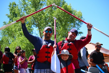 a group of people posing for the camera with their paddles on a pagosa springs town run with pagosa adventure in pagosa springs, colorado