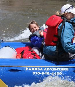 a boy smiling for the camera on a pagosa springs town run with pagosa adventure in pagosa springs, colorado