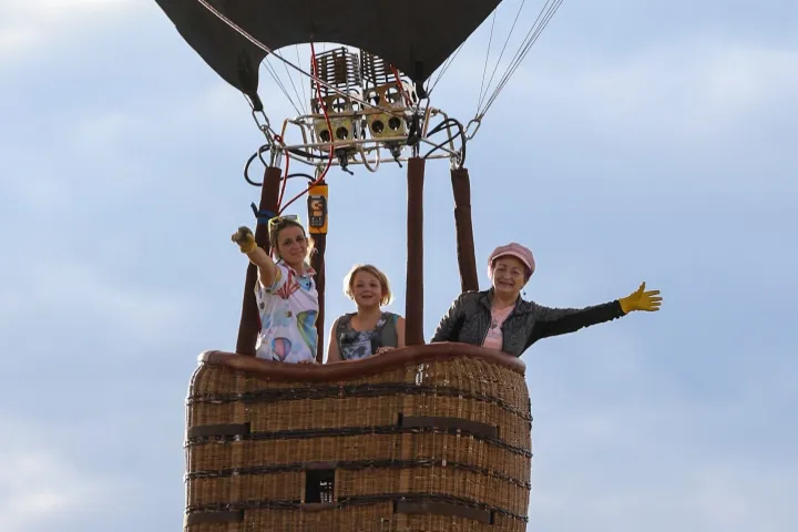 people waving to the camera on board pagosa adventure's hot air balloon in pagosa springs, colorado