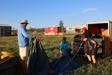 a group of two setting up pagosa adventure's hot air balloon in pagosa springs, colorado