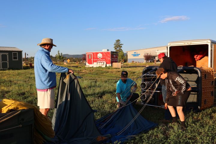 a group of two setting up pagosa adventure's hot air balloon in pagosa springs, colorado