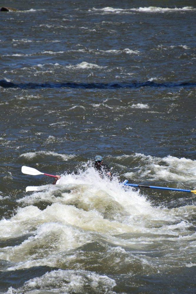 a person riding a wave on top of a body of water