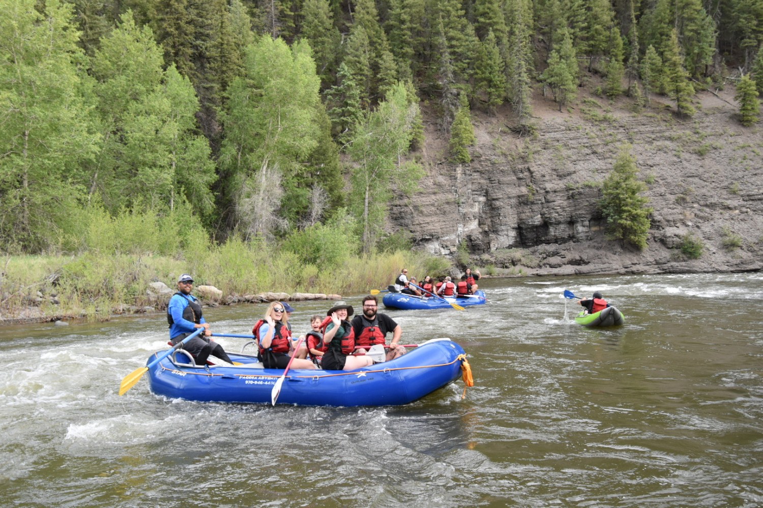 a group of people on a raft in a body of water