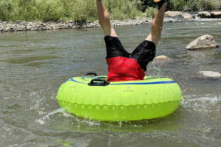 a person riding a surf board on a body of water