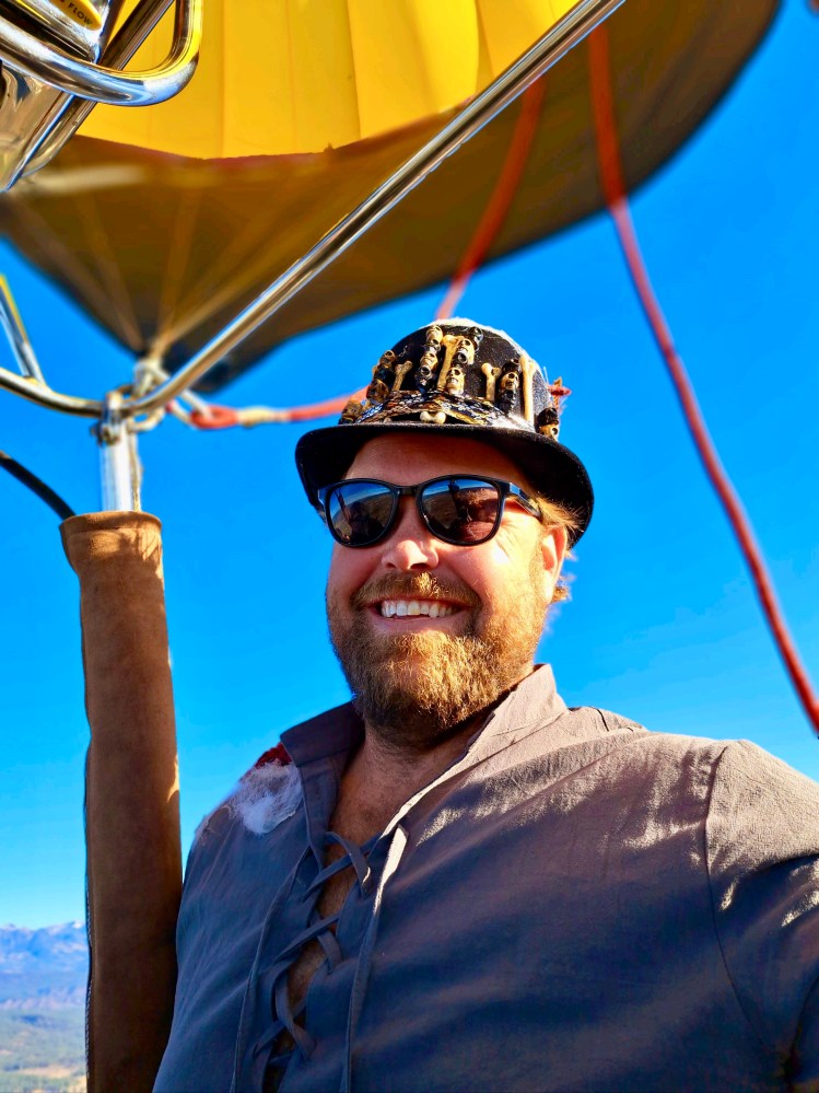 a man wearing a hat and sunglasses