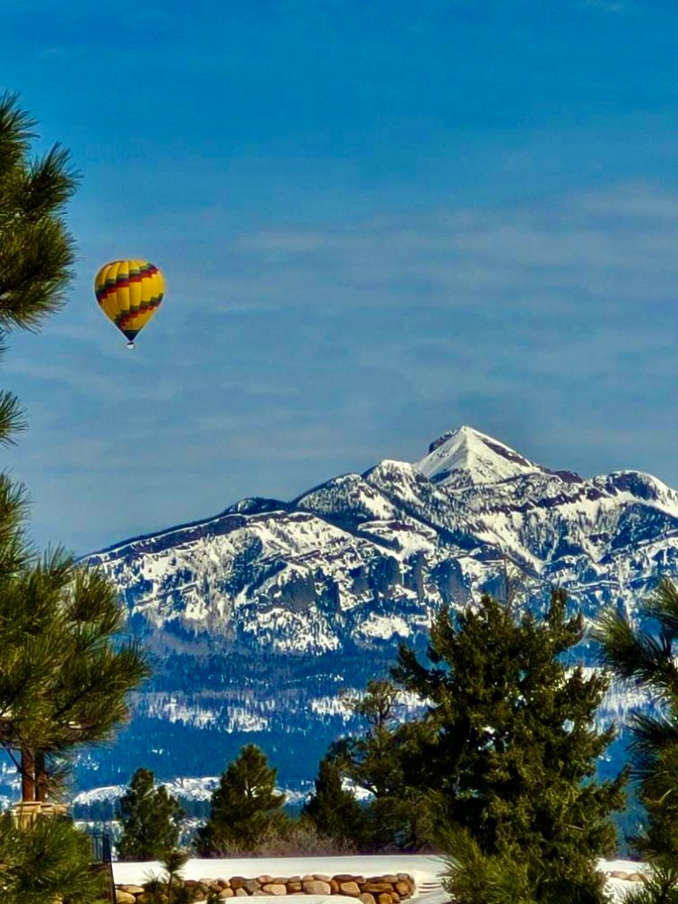 a person flying through the air balloon in the sky