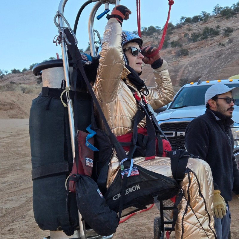 a group of people that are standing in the sand