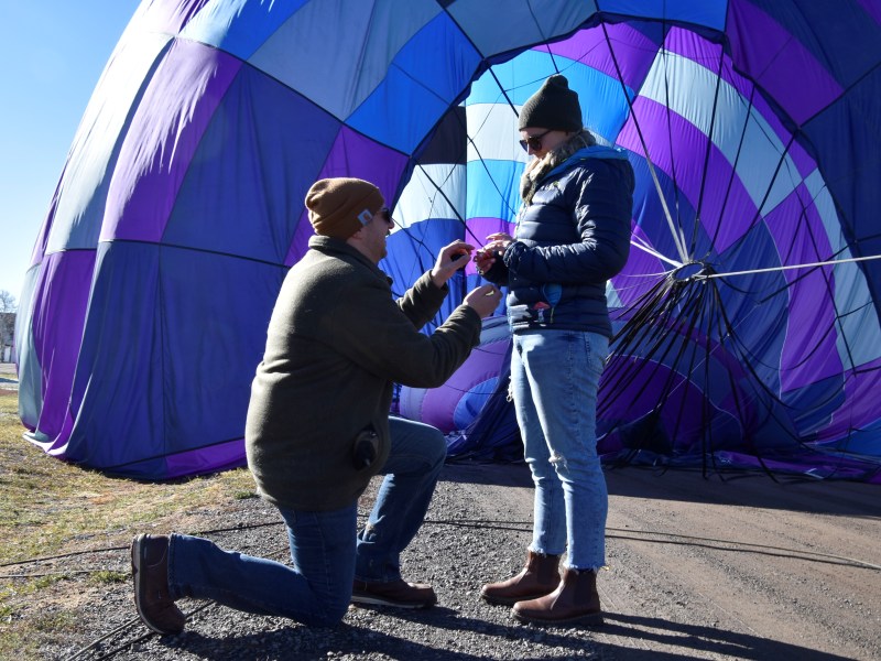 a person holding a purple umbrella