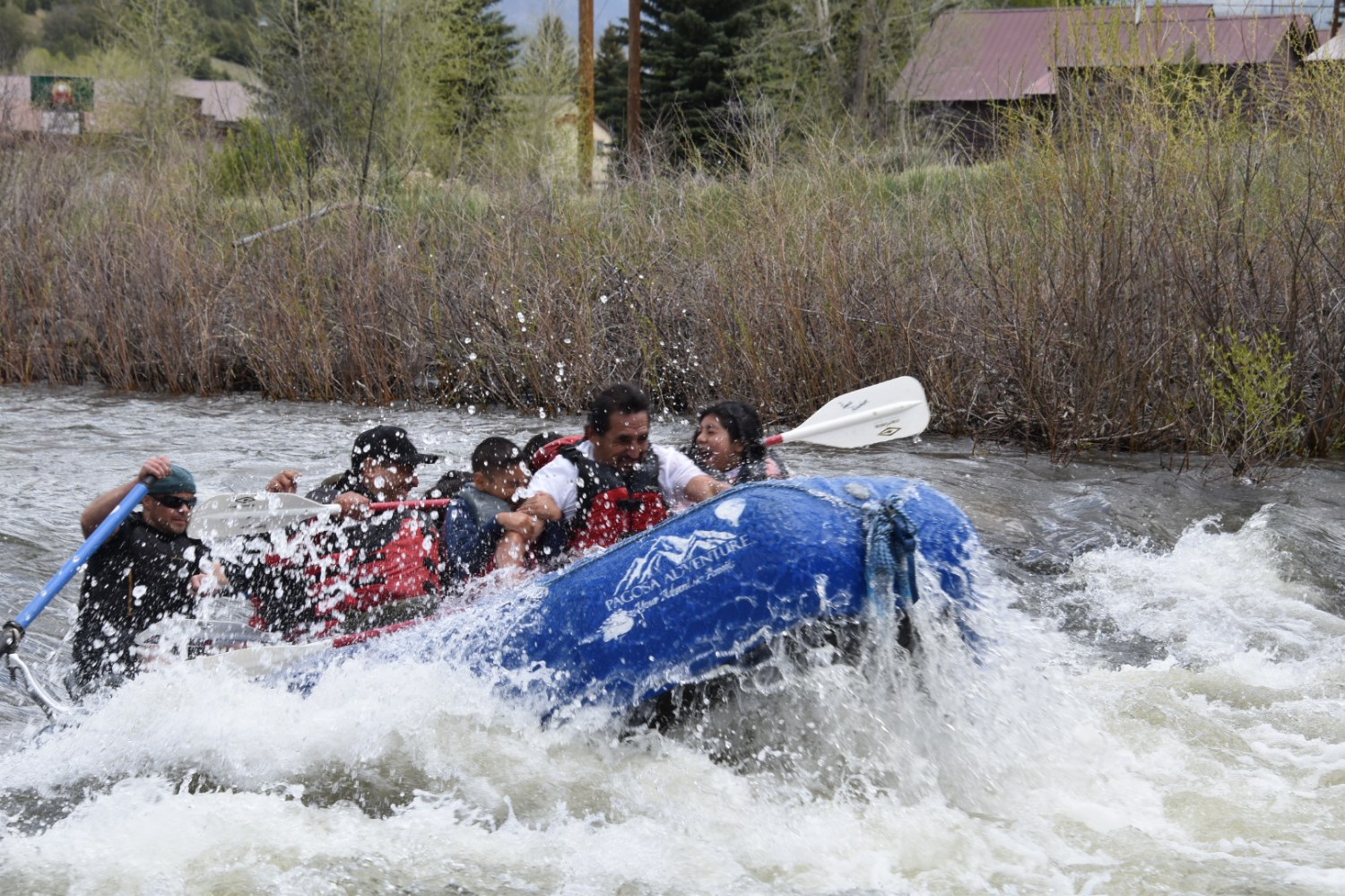 a group of people riding on a raft in a body of water