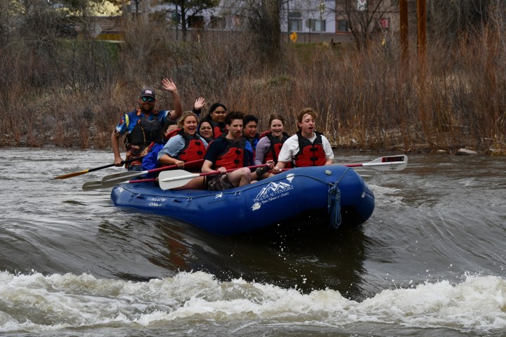 a group of people riding on a raft in a body of water