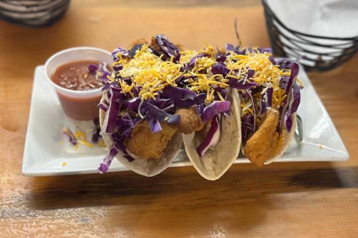 a plate of food sitting on top of a wooden table